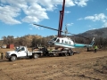 A Boom Truck Gently Lifts a Helicopter